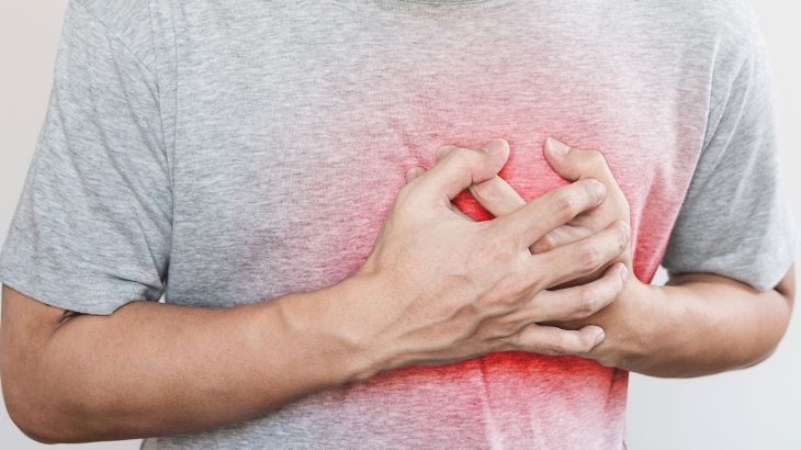 a man touching his heart, with red highlight of heart attack, heart failure and others heart disease