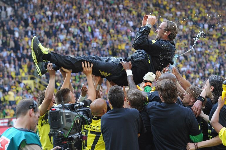 DORTMUND, GERMANY - APRIL 30: Juergen Klopp, head coach of Dortmund is tossed in the air by his players after winning the league title at the end of the Bundesliga match between Borussia Dortmund and 1. FC Nuernberg at Signal Iduna Park on April 30, 2011 in Dortmund, Germany. (Photo by Stuart Franklin/Bongarts/Getty Images)
