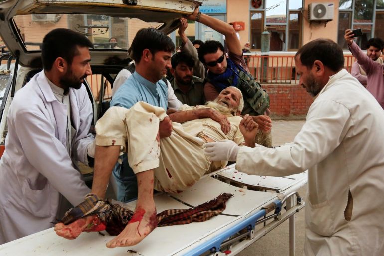 ATTENTION EDITORS - SENSITIVE MATERIAL. THIS IMAGE MAY OFFEND OR DISTURB Men carry an injured person to a hospital after a bomb blast at a mosque, in Jalalabad, Afghanistan October 18, 2019.REUTERS/Parwiz