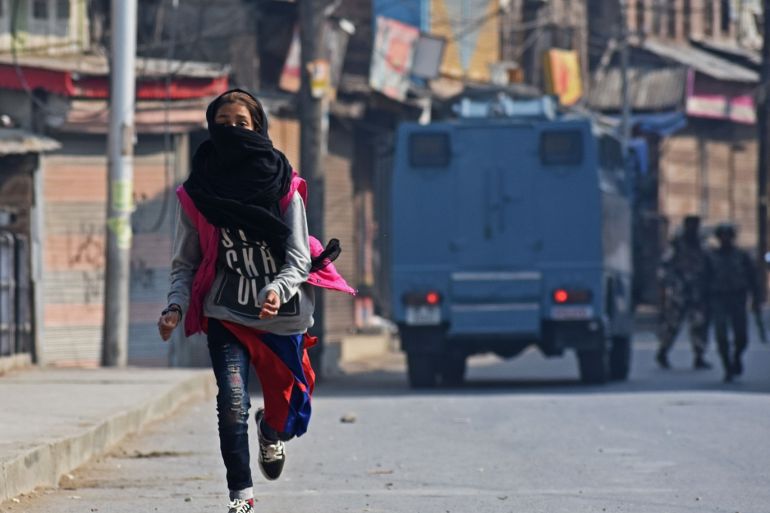 Clashes erupt in Srinagar following the visit of foreign delegat- - SRINAGAR,KASHMIR,INDIA-OCTOBER 29 : A female protester runs after Indian police chased the protesters in Srinagar,Kashmir on October 29, 2019. Protest and clashes were reported from many areas of Kashmir following the visit of group 27 European Lawmakers to the Kashmir valley.The delagation will access the situation across Kashmir after Indian government revoked Article 370 of its constitution which granted Kashmir autonomy.