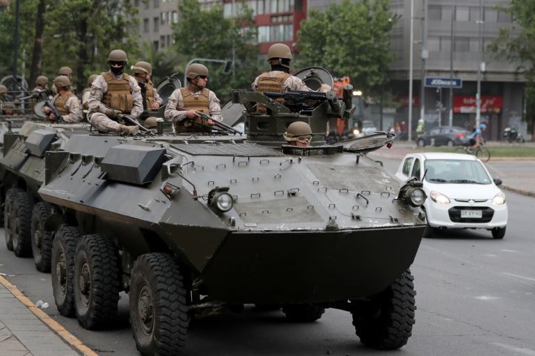Soldiers ride an armoured transporter as they patrol the city after a previous day's protest against the increase in subway ticket prices in Santiago, Chile, October 20, 2019. REUTERS/Ivan Alvarado