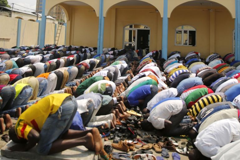 People attend Friday prayers in street around Bisa mosque at downtown of Bata January 23, 2015. According to the U.S. State Department International Religious Freedom Report,Muslims comprise less than 1 percent of the population of Equatorial Guinea, most coming from other countries like Mali, Burkina Faso, and Senegal. REUTERS/Amr Abdallah Dalsh (EQUATORIAL GUINEA - Tags: SOCIETY RELIGION)