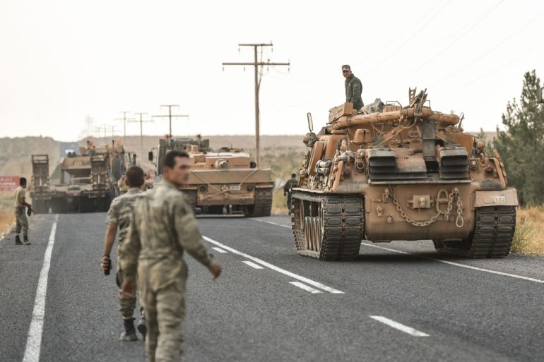 CEYLANPINAR, TURKEY - OCTOBER 18: A Turkish soldiers preparer the tanks as they secures the road before army tanks start moving towards the Syrian border on October 18, 2019 in Ceylanpinar, Turkey. Turkish forces appeared to continue shelling targets in Northern Syria despite yesterday's announcement, by U.S. Vice President Mike Pence, that Turkey had agreed to a ceasefire in its assault on Kurdish-held towns near its border. (Photo by Burak Kara/Getty Images)