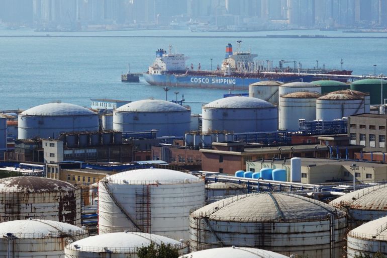 A China Ocean Shipping Company (COSCO) vessel is seen near oil tanks at the China National Petroleum Corporation (CNPC)'s Dalian Petrochemical Corp in Dalian, Liaoning province, China October 15, 2019. REUTERS/Stringer ATTENTION EDITORS - THIS IMAGE WAS PROVIDED BY A THIRD PARTY. CHINA OUT.