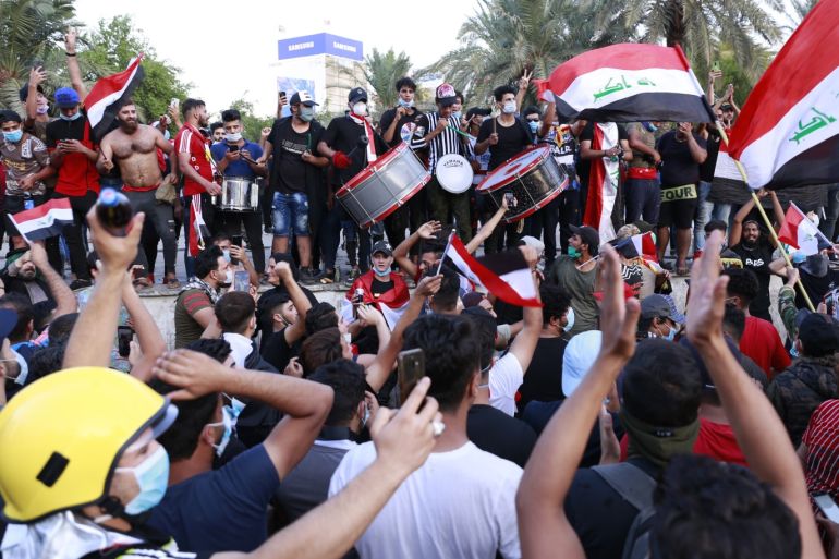 Anti-govt demonstrations in Iraq- - BAGHDAD, IRAQ - OCTOBER 26: Iraqi demonstrators shout slogans as they gather for a protest against unemployment, corruption and lack of public services, at Tahrir Square in Baghdad, Iraq on October 26, 2019.