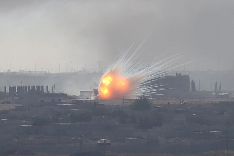 An explosion is seen over the Syrian town of Ras al-Ain as seen from the Turkish border town of Ceylanpinar, Sanliurfa province, Turkey, October 12, 2019. REUTERS/Stoyan Nenov