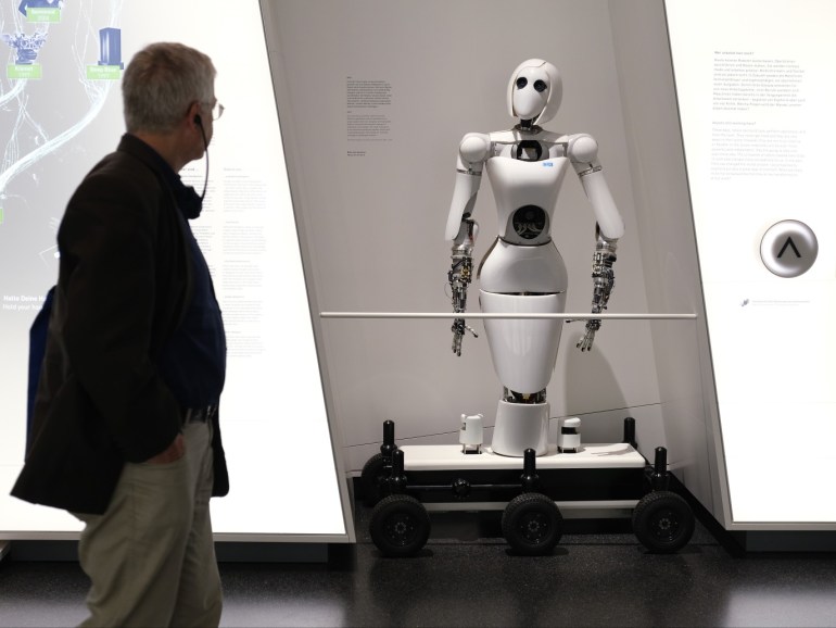 BERLIN, GERMANY - AUGUST 27: A visitor looks at an AILA (Artificial Intelligence Lightweight Android) robot during a press preview at the new Futurium museum in the city center on August 27, 2019 in Berlin, Germany. The museum, which will open to the public on September 5, asks how humanity will live in the future and seeks answers through exhibits, many of them interactive, that draw on nature, architecture, robotics, artificial intelligence, science and other fields. (Photo by Sean Gallup/Getty Images)