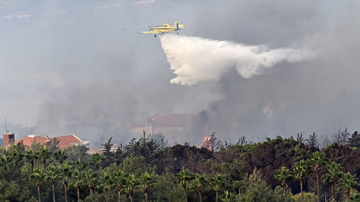 Wildfire in Lebanon- - BEIRUT, LEBANON - OCTOBER 15: A fire fighting aircraft pours water after fire took out forests in the mountainous area that flank Damour river near the village of Meshref in Lebanon's Shouf mountains, southeast of the capital Beirut, Lebanon on October 15, 2019. Flames devoured large swaths of land in several Lebanese and Syrian regions. The outbreak coincided with high temperatures and strong winds, according to the official media in both countries.