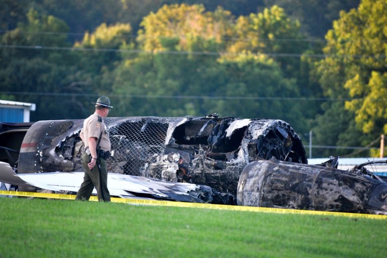 A police officer walks past the wreckage of a plane crash involving NASCAR driver Dale Earnhardt Jr. and his family, who survived the incident, in Elizabethton, Tennessee, U.S. August 15, 2019. REUTERS/Charles Mostoller