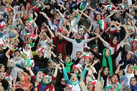 epa07910552 Iranian women cheer during the FIFIA World Cup qualification match between Iran and Cambodia, at the Azadi stadium in Tehran, Iran 10 October 2019. Media reported that thousands of Iranian women are set to watch a men's FIFA Asian World...