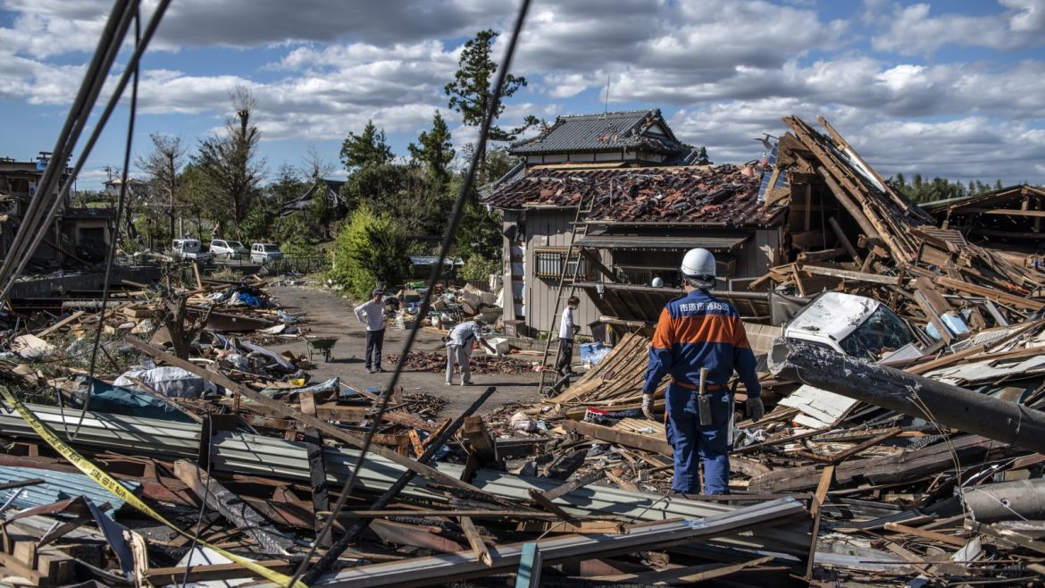 CHIBA, JAPAN - OCTOBER 13: People sort through the debris of buildings that were destroyed by a tornado shortly before the arrival of Typhoon Hagibis, on October 13, 2019 in Chiba, Japan. At least five people are reported dead and many others are missing after Typhoon Hagibis, one of the most powerful storms in decades, swept across Japan. (Photo by Carl Court/Getty Images)