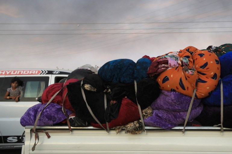 Belongings are seen at a back of a truck as people flee Ras al Ain town, Syria October 9, 2019. REUTERS/Rodi Said