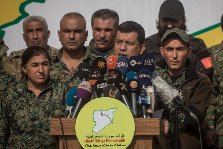 DEIR AL ZOR, SYRIA - MARCH 23: Syrian Democratic Force's commander in chief Mazloum Kobani (C) speaks during a SDF victory ceremony announcing the defeat of ISIL in Baghouz held at Omer Oil Field on March 23, 2019 in Deir Al Zor, Syria. The Kurdish-led and American-backed Syrian Defense Forces (SDF) declared on Saturday the