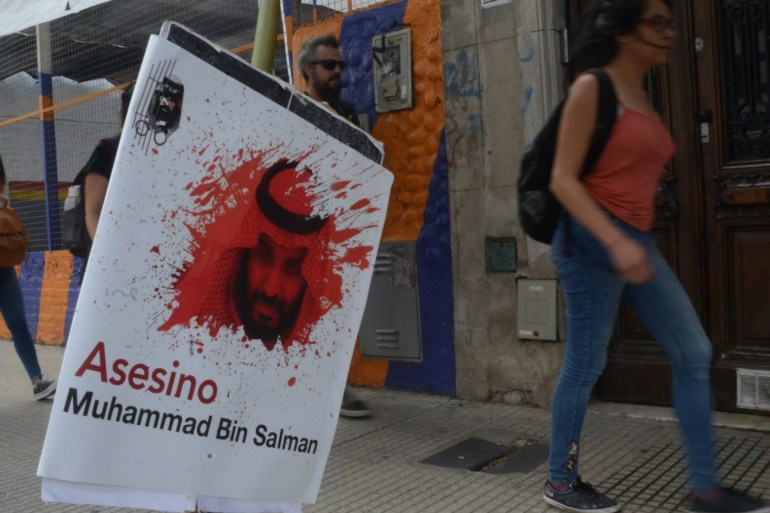 BUENOS AIRES, ARGENTINA - NOVEMBER 30: A banner depicting Crown Prince of Saudi Arabia Mohammad bin Salman al-Saud covered with blood and calling him murderer is seen in the street as people walk past during a protest against Argentina G20 Leaders' Summit 2018 on November 30, 2018 in Buenos Aires, Argentina. (Photo by Paula Ribas/Getty Images)