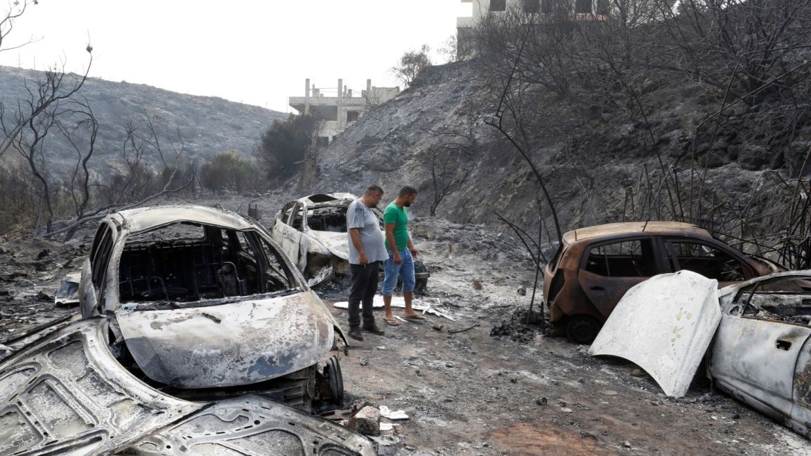 People look at burned vehicles after wildfires swept through Damour, south of Beirut, Lebanon October 15, 2019. REUTERS/Mohamed Azakir