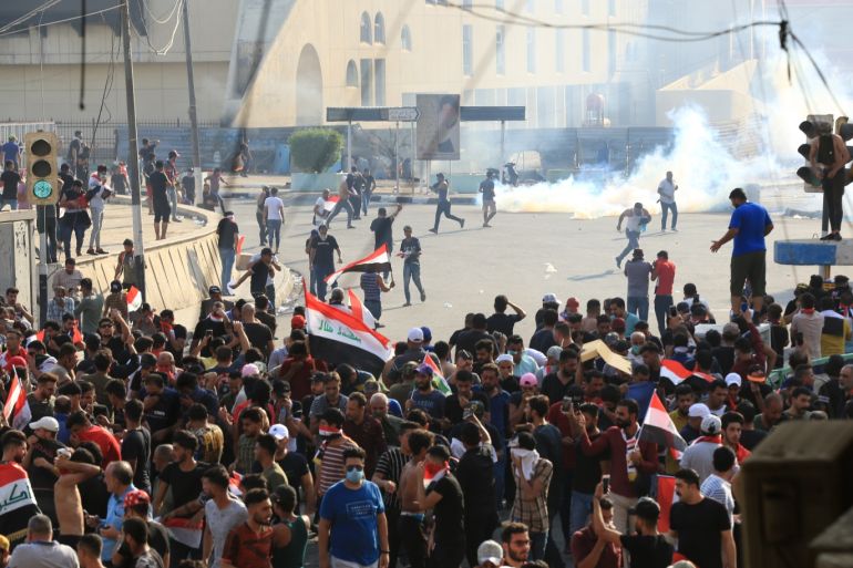 Anti-government protests in Iraq- - BAGHDAD, IRAQ - OCTOBER 1 : Iraqi demonstrators try to enter Green Zone as they gather for a demonstration against Iraqi government in Baghdad, Iraq on October 01, 2019.