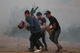 'Great March of Return' demonstrations in Gaza- - GAZA CITY, GAZA - OCTOBER 25: A tear gas affected Palestinian is being carried away as Israeli forces intervene Palestinians with tear gas canisters during a demonstration within the