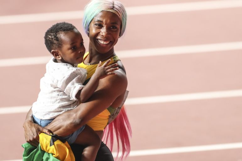 World Athletics Championships in Qatar- - DOHA, QATAR -SEPTEMBER 29: Shelly-Ann Fraser-Pryce of Jamaica celebrates with her son Zyon after winning the women's 100m final during the IAAF World Athletics Championships 2019 at the Khalifa Stadium in Doha, Qatar, 29 September 2019.