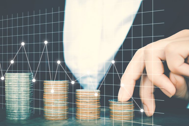 Digital Composite Image Of Businesswoman With Coins Stack And Graphs On Inter Display