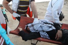 'Great March of Return' demonstrations in Gaza- - GAZA CITY, GAZA - OCTOBER 18: Paramedics carry a wounded during a demonstration within the