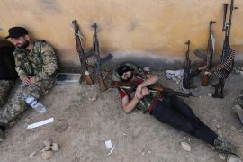 A Turkey-backed Syrian rebel fighter takes a rest near the border town of Tal Abyad, Syria, October 22, 2019. REUTERS/Khalil Ashawi