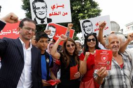 Saloua Samoui, the wife of detained Tunisian media mogul and presidential candidate Nabil Karoui, stands with supporters as she distributes election leaflets for Karoui's Heart of Tunisia party ahead of the upcoming parliamentary elections in Tunis, Tunisia October 3, 2019. Picture taken October 3, 2019. REUTERS/Zoubeir Souissi