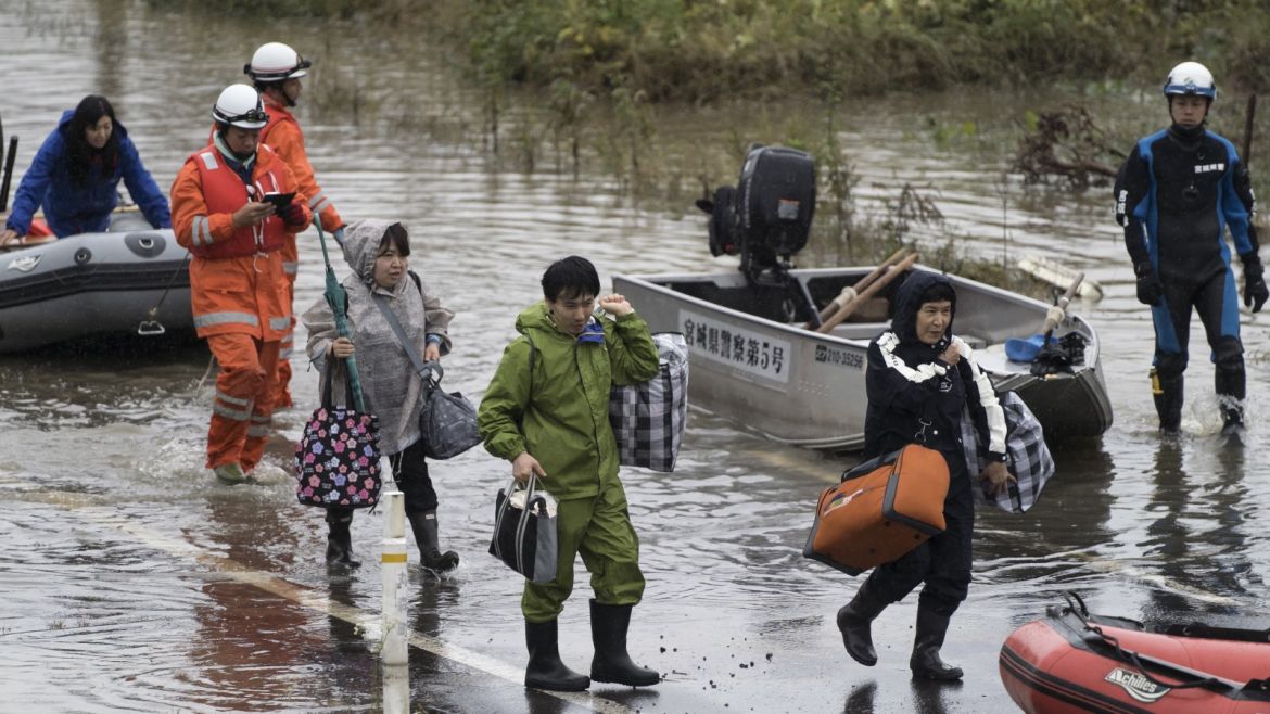 MARUMORI, JAPAN - OCTOBER 14: People are rescued by firefighters in an area that was flooded by Typhoon Hagibis on October 14, 2019 in Marumori, Miyagi, Japan. Japan has mobilised 110,000 rescuer workers after Typhoon Hagibis, the most powerful storm in decades, swept across the country leaving 37 dead and around 20 missing.  (Photo by Tomohiro Ohsumi/Getty Images)