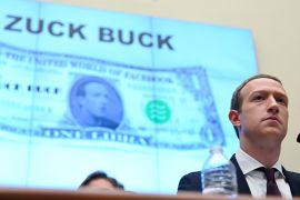 Facebook Chairman and CEO Mark Zuckerberg testifies in front of a projection of a