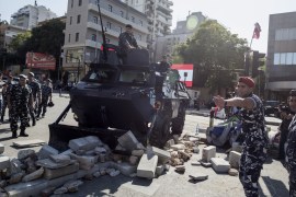 BEIRUT, LEBANON - OCTOBER 30: Police remove a barricade installed by protesters who had been occupying the Ring Bridge as anti-government protesters agree to re-open the highway linking the east and west of the city, on October 30, 2019, in Beirut, Lebanon. Lebanese Prime Minister Saad al Hariri yesterday resigned on what was the 13th day of unrest across the country, sparked by the imposition of new taxes and anger at state corruption. (Photo by Sam Tarling/Getty Image