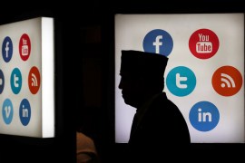 A delegate of the 41st annual meeting of the Islamic Development Bank (IDB) walks in front of social media logos at the Jakarta Convention Center in Jakarta, Indonesia, May 16, 2016. REUTERS/Beawiharta TPX IMAGES OF THE DAY