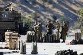 Israeli soldiers stand next to shells and a mobile artillery unit near the Israeli side of the border with Syria in the Israeli-occupied Golan Heights August 26, 2019. REUTERS/Amir Cohen