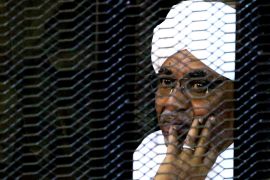 Sudan's former president Omar Hassan al-Bashir sits inside a cage at the courthouse where he is facing corruption charges, in Khartoum, Sudan September 28, 2019. REUTERS/Mohamed Nureldin Abdallah