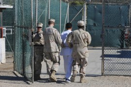 US Navy guards escort a detainee through Camp Delta at Guantanamo Bay naval base in a June 10, 2008 file photo provided by the US Department of Defense. President Barack Obama urged lawmakers on Tuesday to give his plan to close the U.S. military prison at Guantanamo Bay, Cuba, a