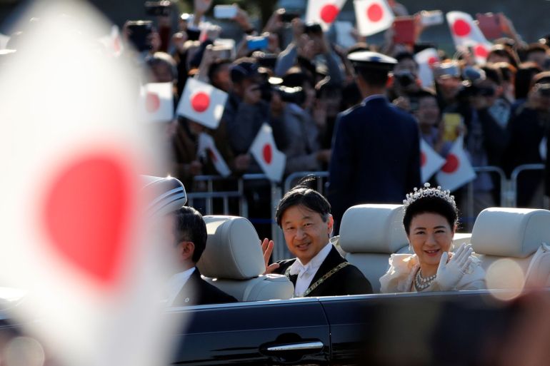 Japan's Emperor Naruhito and Empress Masako wave to well-wishers during their royal parade to mark the enthronement of Japanese Emperor Naruhito in Tokyo, Japan November 10, 2019. REUTERS/Kim Kyung-Hoon