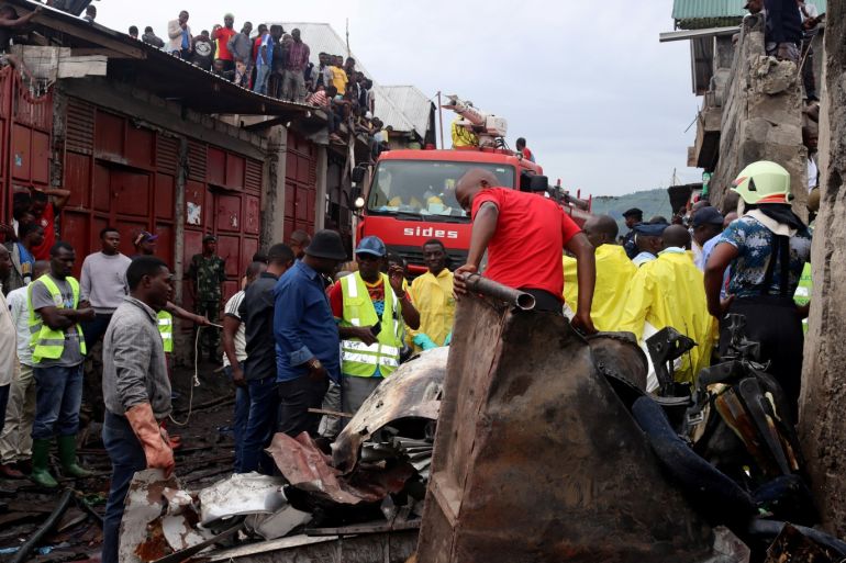 Rescuers and civilians gather at the site where a Dornier 228-200 plane operated by local company Busy Bee crashed into a densely populated neighborhood in Goma, eastern Democratic Republic of Congo November 24, 2019. REUTERS/Fiston Mahamba