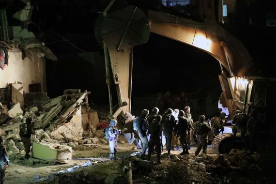 A bulldozer demolishes Palestinian houses in the West Bank village of Biet Kahel near Hebron, 28 November 2019. The Israeli army has allegedly demolished four houses belonging to Palestinian men accused of murdering Israeli soldier in an August, according to a statement issued by the army. EPA-EFE/ABED AL HASHLAMOUN