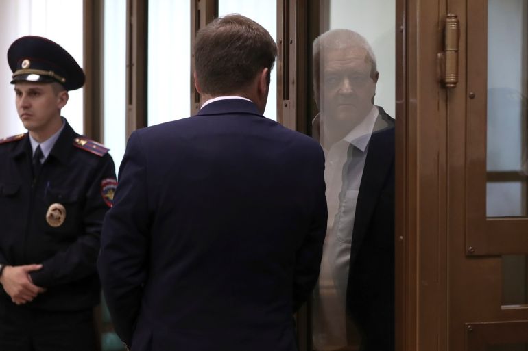 Frode Berg, a Norwegian national detained by Russian authorities on suspicion of espionage, listens to his lawyer while standing inside a defendants' cage as he attends a court hearing in Moscow, Russia April 16, 2019. REUTERS/Evgenia Novozhenina