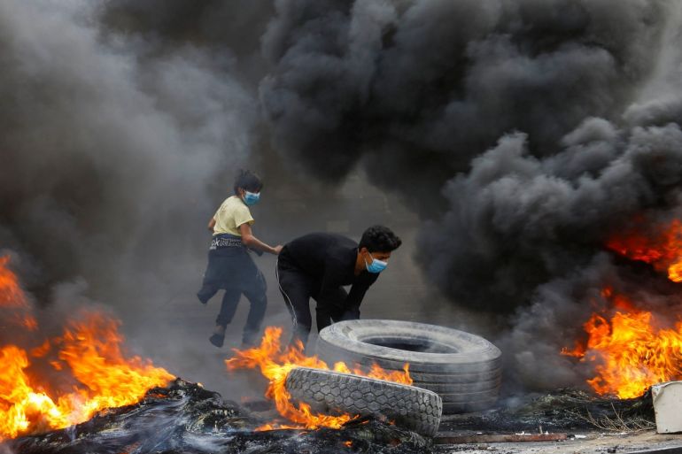 Iraqi demonstrators burn tires during the ongoing anti-government protests in Najaf, Iraq November 18, 2019. REUTERS/Alaa al-Marjani