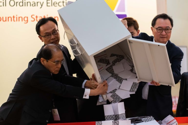 HONG KONG, CHINA - NOVEMBER 24: Barnabus Fung (2nd R) and Patrick Nip Tak-kuen (2nd L) empty a ballot box to count votes at a polling station on November 24, 2019 in Hong Kong, China. Hong Kong held its district council election on Sunday as anti-government protests continue into a sixth month, with demands for an independent inquiry into police brutality, the retraction of the word