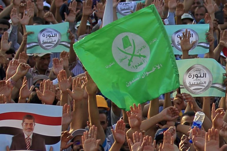 Members of the Muslim Brotherhood and supporters of Egyptian President Mohamed Mursi shout slogans and wave the flags of the brotherhood during a protest around the Raba El-Adwyia mosque square in Nasr City, in the suburb of Cairo June 29, 2013. Mass demonstrations across Egypt on Sunday may determine its future, two and half years after people power toppled a dictator they called Pharaoh and ushered in a democracy crippled by bitter divisions. The protesters' goal again is to unseat a president, this time their first freely elected leader, the Islamist Mursi. Liberal leaders say nearly half the voting population - 22 million people - have signed a petition calling for change. REUTERS/Mohamed Abd El Ghany (EGYPT - Tags: POLITICS CIVIL UNREST)