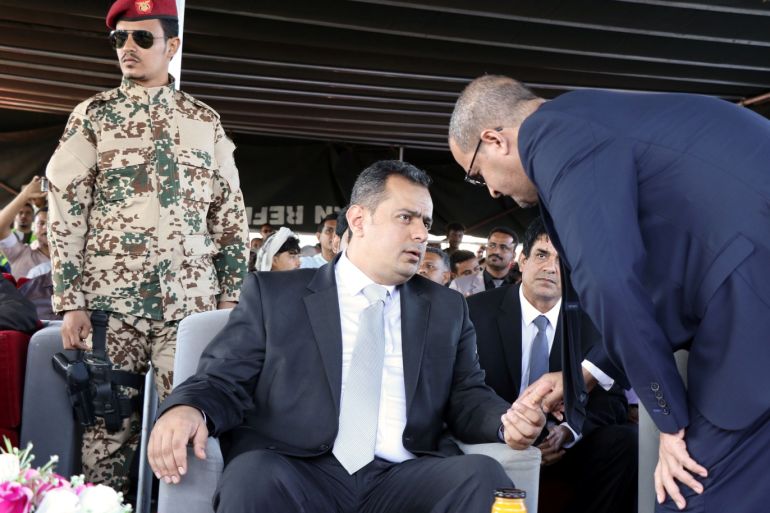 Yemen's Prime Minister Maeen Abdulmalik Saeed talks to a port official during a ceremony marking the delivery of cranes as a grant from Saudi Arabia to the Aden port, Yemen December 12, 2018. Picture taken December 12, 2018. REUTERS/Fawaz Salman