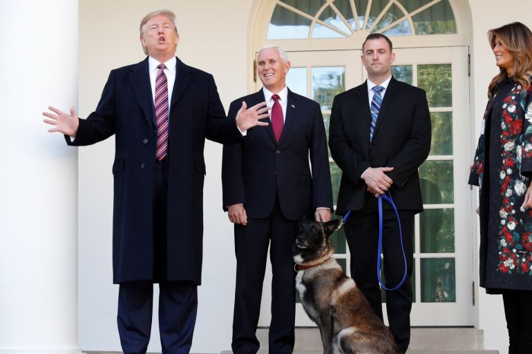 U.S. President Donald Trump speaks to the news media next to Vice President Mike Pence and Conan, the U.S. military dog that participated in and was injured in the U.S. raid in Syria that killed ISIS leader Abu Bakr al-Baghdadi, during a photo opportunity with the dog and a military handler on the colonnade of the West Wing of the White House in Washington, U.S. November 25, 2019. REUTERS/Tom Brenner