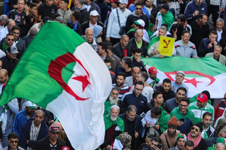 Demonstrators carry national flags during a protest to demand that a presidential election next month be cancelled until the old ruling guard step aside and the army quit politics, in Algiers, Algeria November 29, 2019. REUTERS/Ramzi Boudina