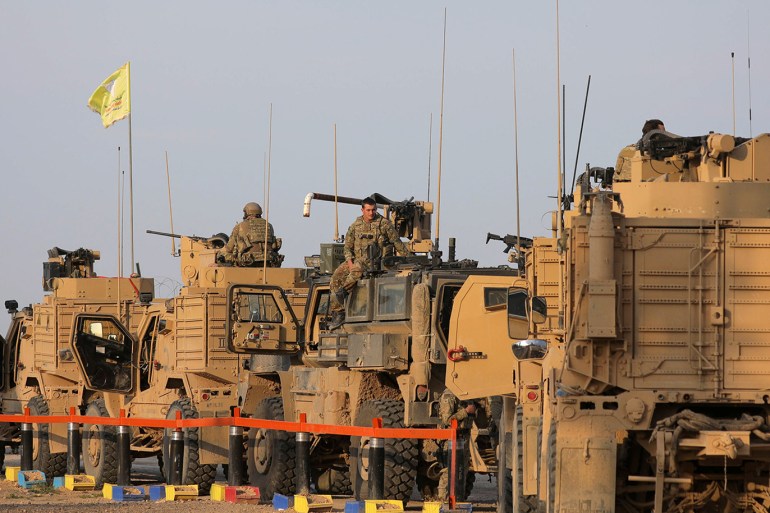 American soldiers stand near military trucks, at al-Omar oil field in Deir Al Zor, Syria March 23, 2019. REUTERS/Rodi Said