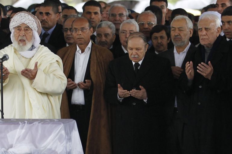 Algerian President Abdelaziz Bouteflika (C),Tunisian President Moncef Marzouki (L), leader of the Islamist Ennahda movement Rached Ghannouchi (2nd R) and Algerian former President Chadli Bendjedid (R) pray during the funeral of the first President of independent Algeria Ahmed Ben Bella at Al Alia Cemetery in Algiers April 13, 2012. Ahmed Ben Bella helped lead Algeria's fight for independence from France and after victory became its first president, a figure who symbolised the romance of the national liberation struggle before the harsh reality of running a country intruded. He died on Wednesday morning in the Algerian capital, aged 96, after an illness, the state-run news agency reported. REUTERS/Louafi Larbi (ALGERIA - Tags: POLITICS OBITUARY)