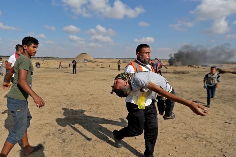 A medic helps a Palestinian demonstrator affected by tear gas during an anti-Israel protest at the Israel-Gaza border fence, in the southern Gaza Strip November 1, 2019. REUTERS/Ibraheem Abu Mustafa