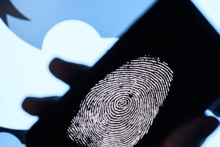 LONDON, ENGLAND - AUGUST 09: In this photo illustration, a thumbprint is displayed on a mobile phone as the logo for the Twitter social media network is projected onto a screen on August 09, 2017 in London, England. With around 328 million users worldwide, Twitter has gone from a small start-up in for the public 2006 to a broadcast tool of politicians and corporations in 2017. (Photo by Leon Neal/Getty Images)