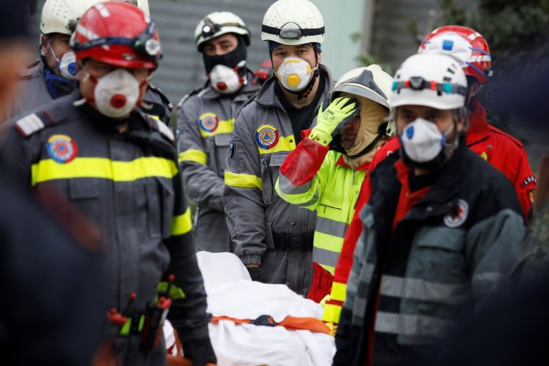 Emergency personnel carry a dead body on a stretcher as they work in a collapsed building in Durres, after an earthquake shook Albania, November 28, 2019. REUTERS/Florion Goga