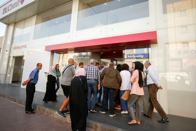 People queue outside a branch of BLC bank in Sidon, Lebanon November 19, 2019. REUTERS/Ali Hashisho
