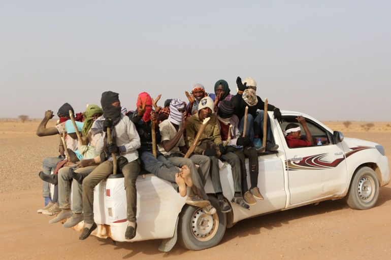 Migrants crossing the Sahara desert into Libya sit on the back of a pickup truck outside Agadez, Niger, May 9, 2016. Picture taken May 9, 2016. To match Analysis EUROPE-MIGRANTS/AFRICA REUTERS/Joe Penney